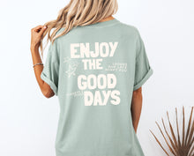 Load image into Gallery viewer, sage garment-dyed coastal graphic t-shirt with “Enjoy the Good Days” back print, styled for a relaxed summer outfit