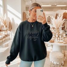 Load image into Gallery viewer, Cozy black fall crewneck sweatshirt featuring a textured 3D puff "Spooky Season" design and bat graphic, perfect for Halloween outfits and autumn fashion.

